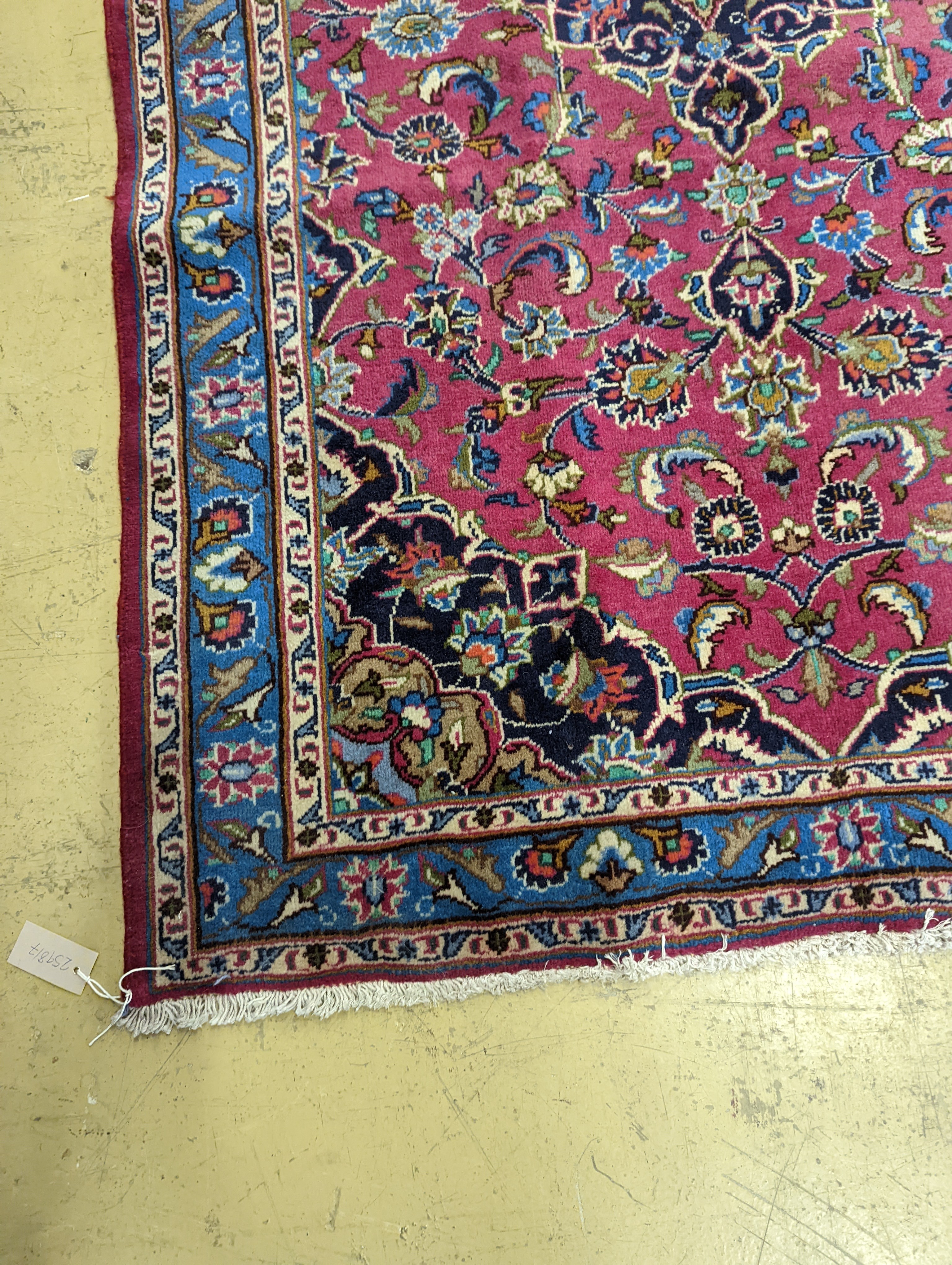 A Najaf Abad claret ground rug, 200 x 114cm